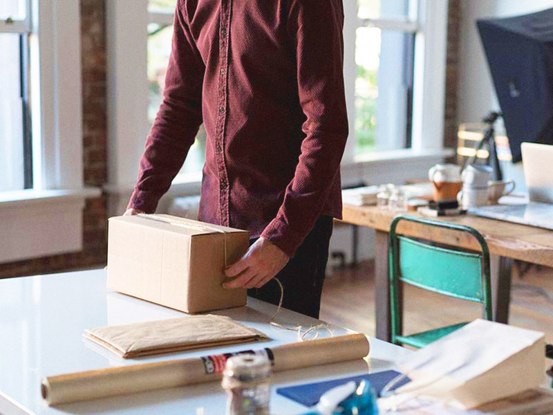 man packaging customer's order